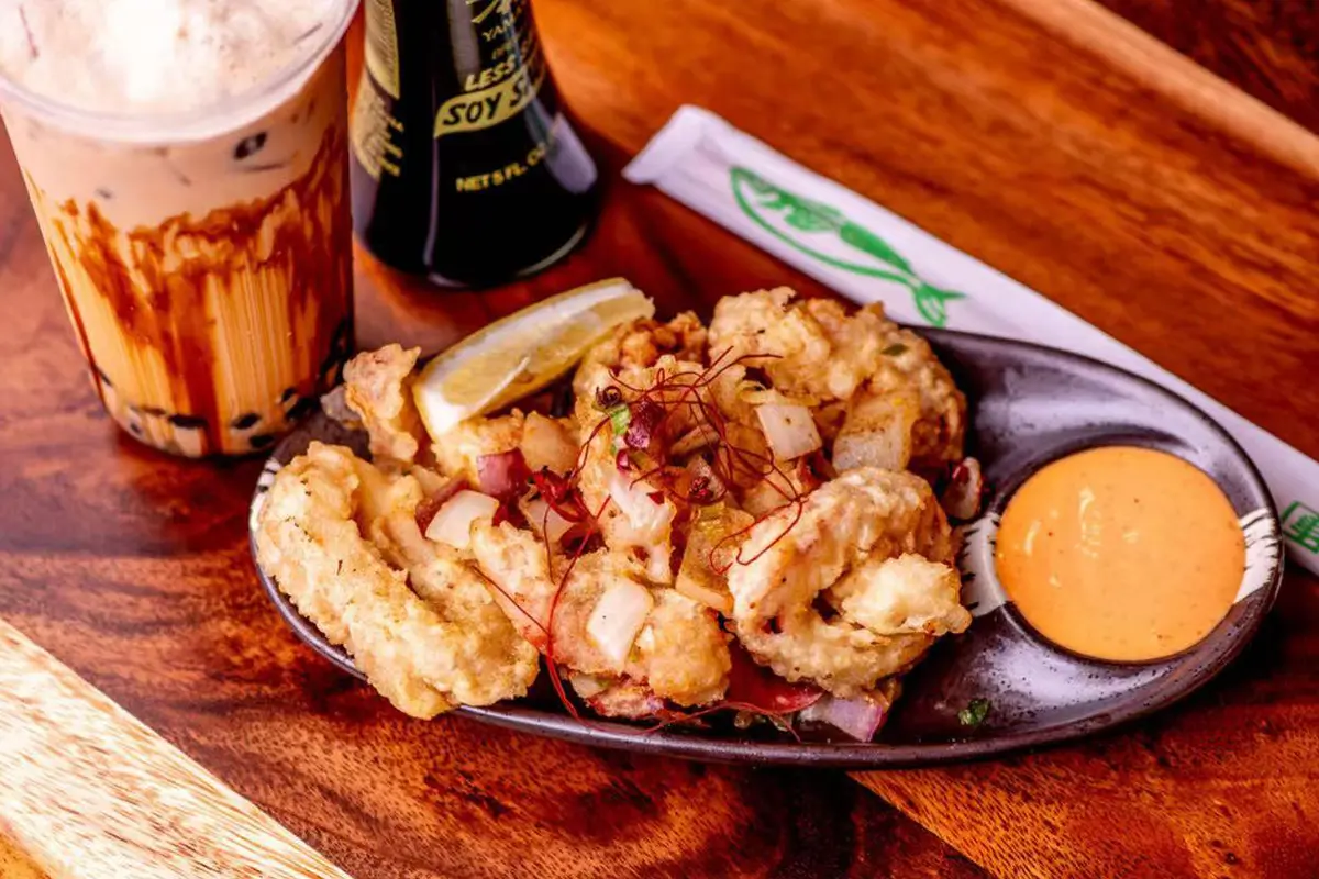 Golden-fried calamari tossed with spicy salt & pepper seasoning, served with lemon wedges and garlic aioli at Kyushu Sushi & Ramen，a Asian Restaurant in Fairfield