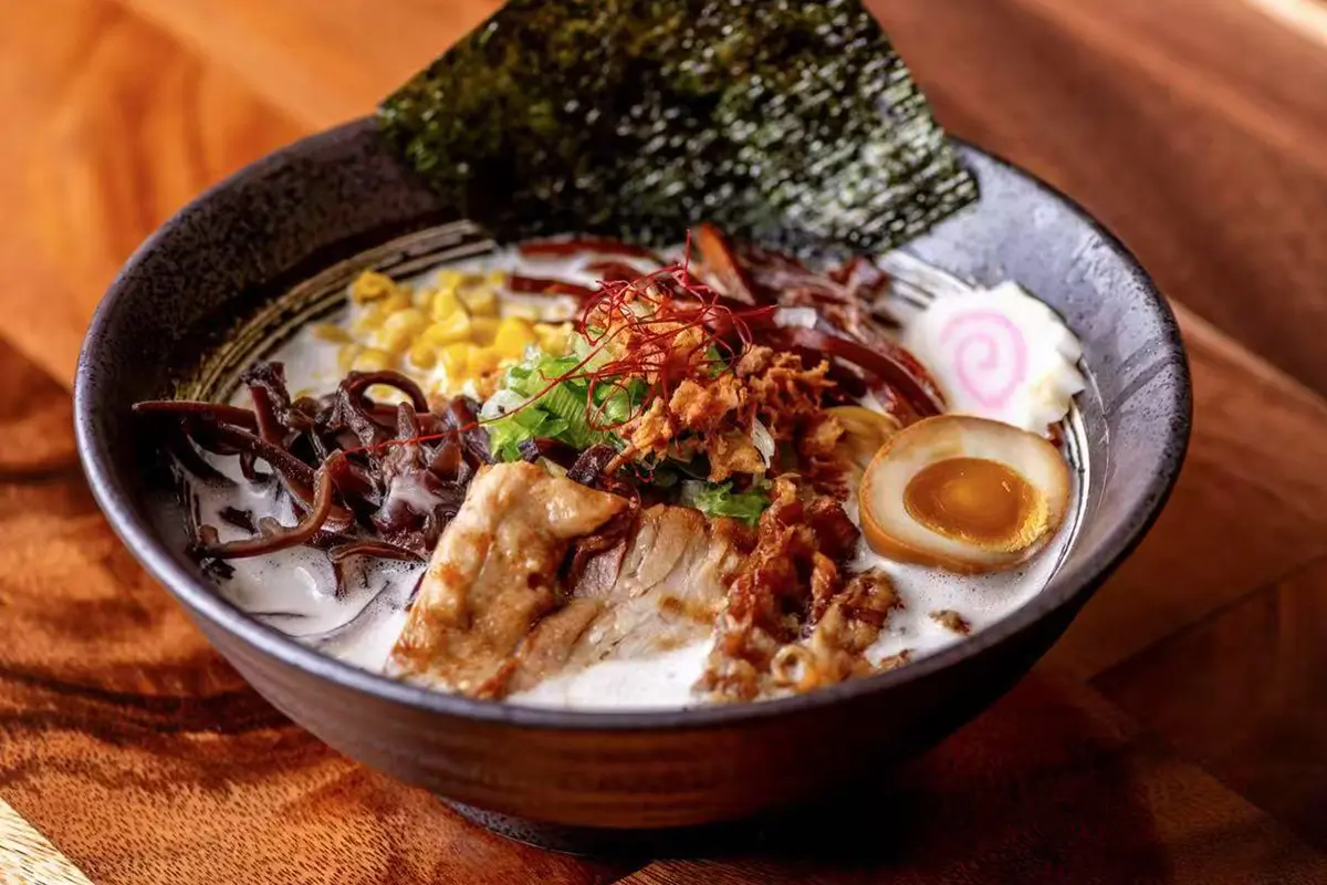 Authentic Kyushu-style tonkotsu ramen with creamy pork bone broth, tender chashu pork, and thin noodles, topped with marinated egg and green onions at Kyushu Sushi & Ramen，a Asian Restaurant in Fairfield